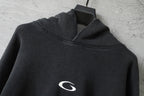 Black hood with drawstring and small white logo on hooded sweatshirt.