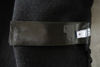 Black fabric label tag inside hooded sweatshirt with printed size text.