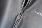 Light gray zip-up sweatshirt detail with metal zipper and BALENCIAGA logo