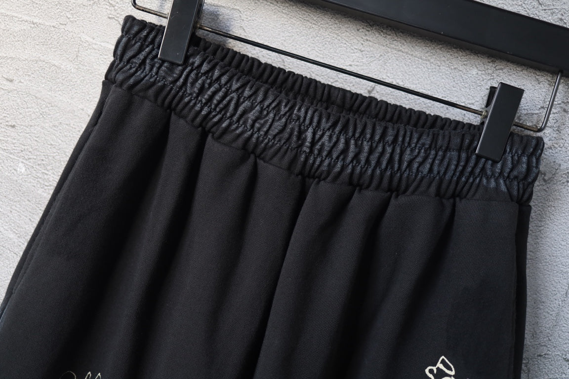 Elastic waistband detail on black wide-leg pants with waistband gathering