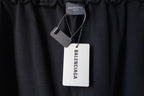 Black pants with hang tags attached near the elastic waistband
