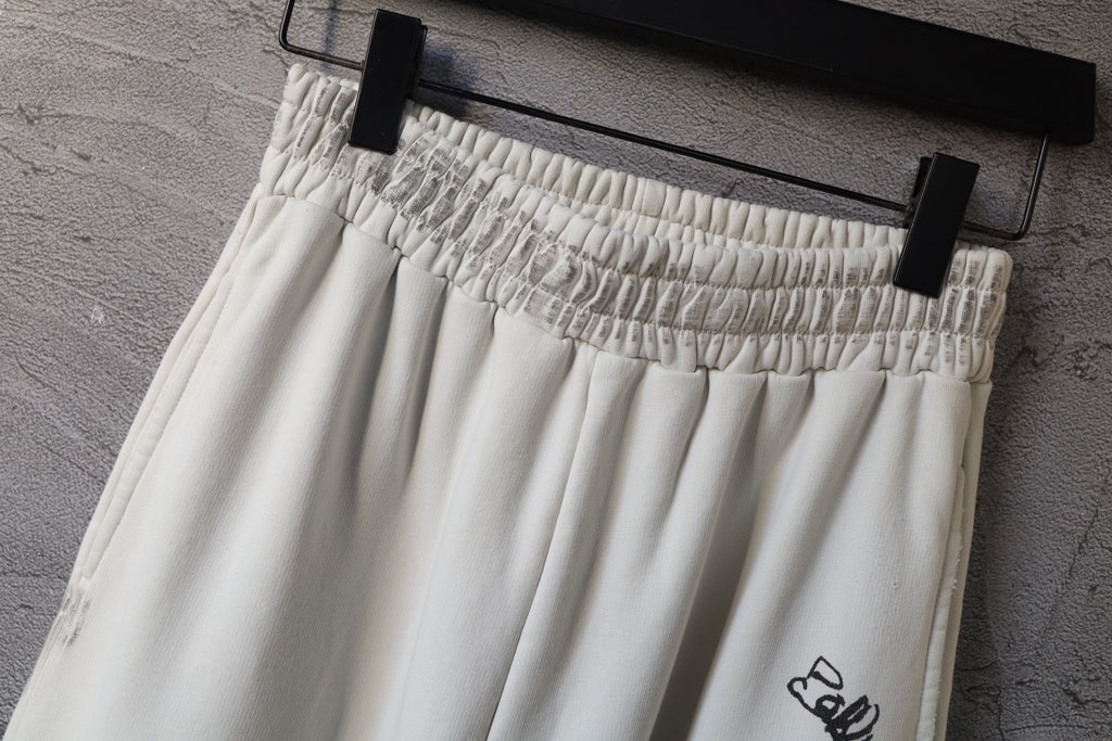 Cream elastic waistband pants with stitched gathers and logo detail