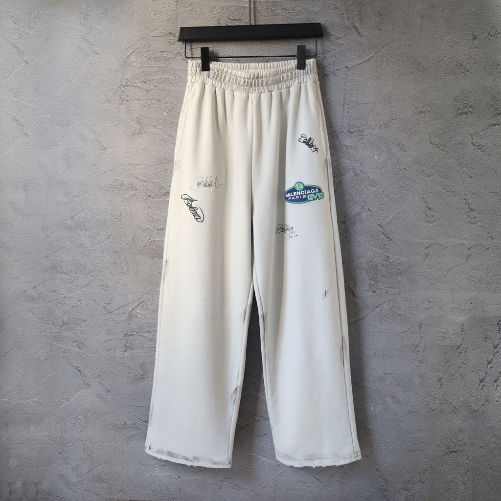 Cream logo print wide-leg pants with elastic waistband and drawstring