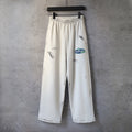Cream logo print wide-leg pants with elastic waistband and drawstring