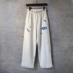 Cream logo print wide-leg pants with elastic waistband and drawstring