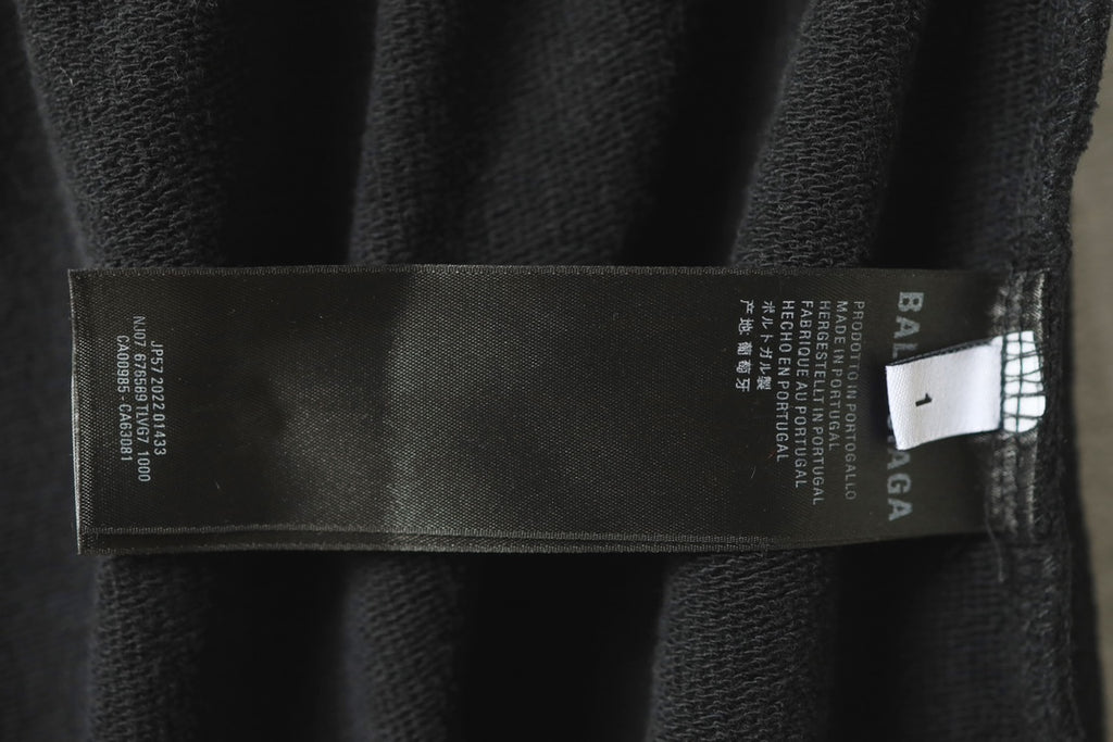 Black pants with inner label tag showing Balenciaga branding and sizing