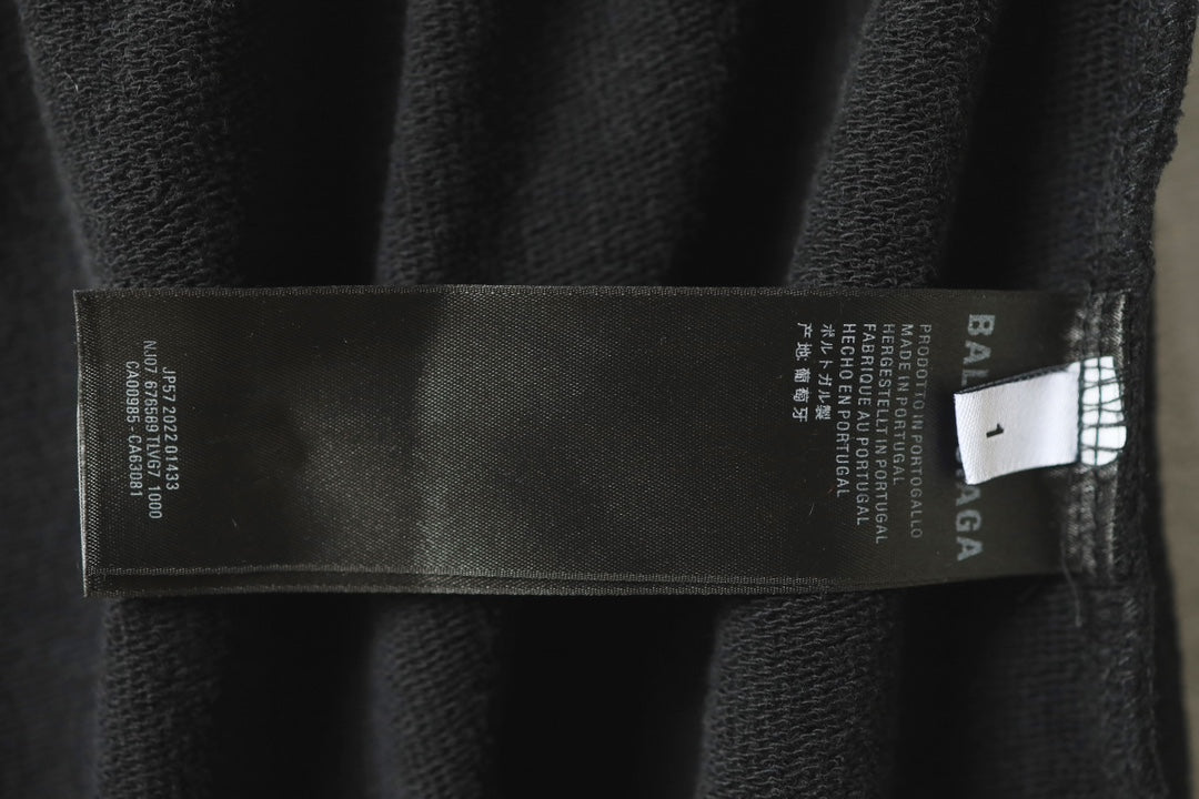 Black pants with inner label tag showing Balenciaga branding and sizing