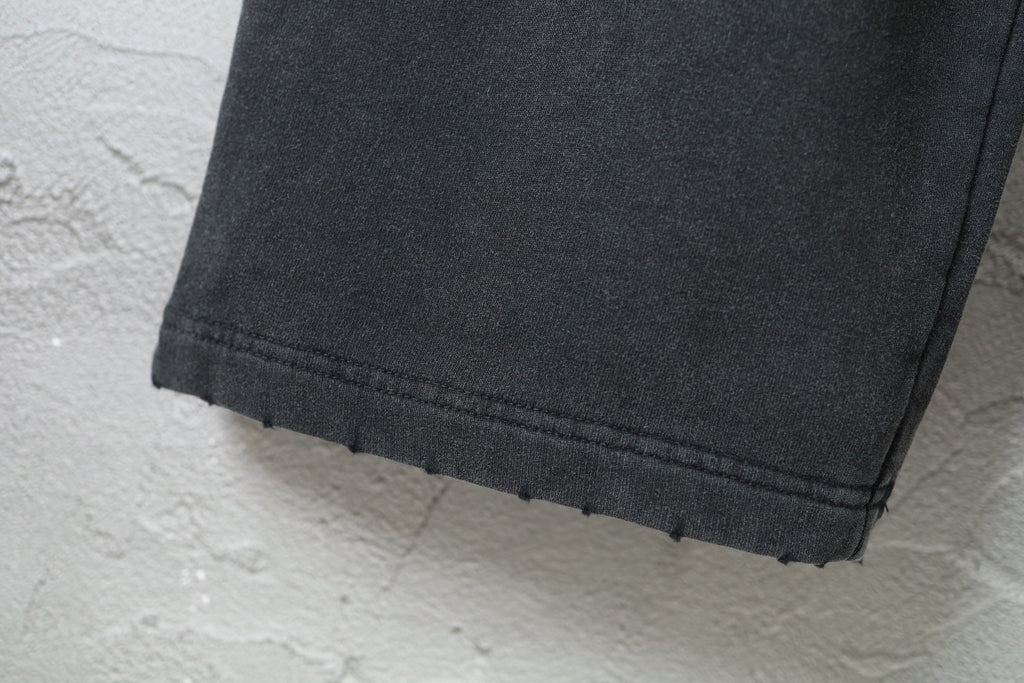Black pants with wide hem, stitched cuff, and ankle-length cut
