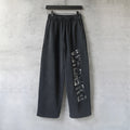 Black wide-leg pants with elastic waistband and long side graphic print