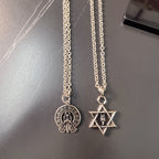 Two silver chains with round and star pendant charms
