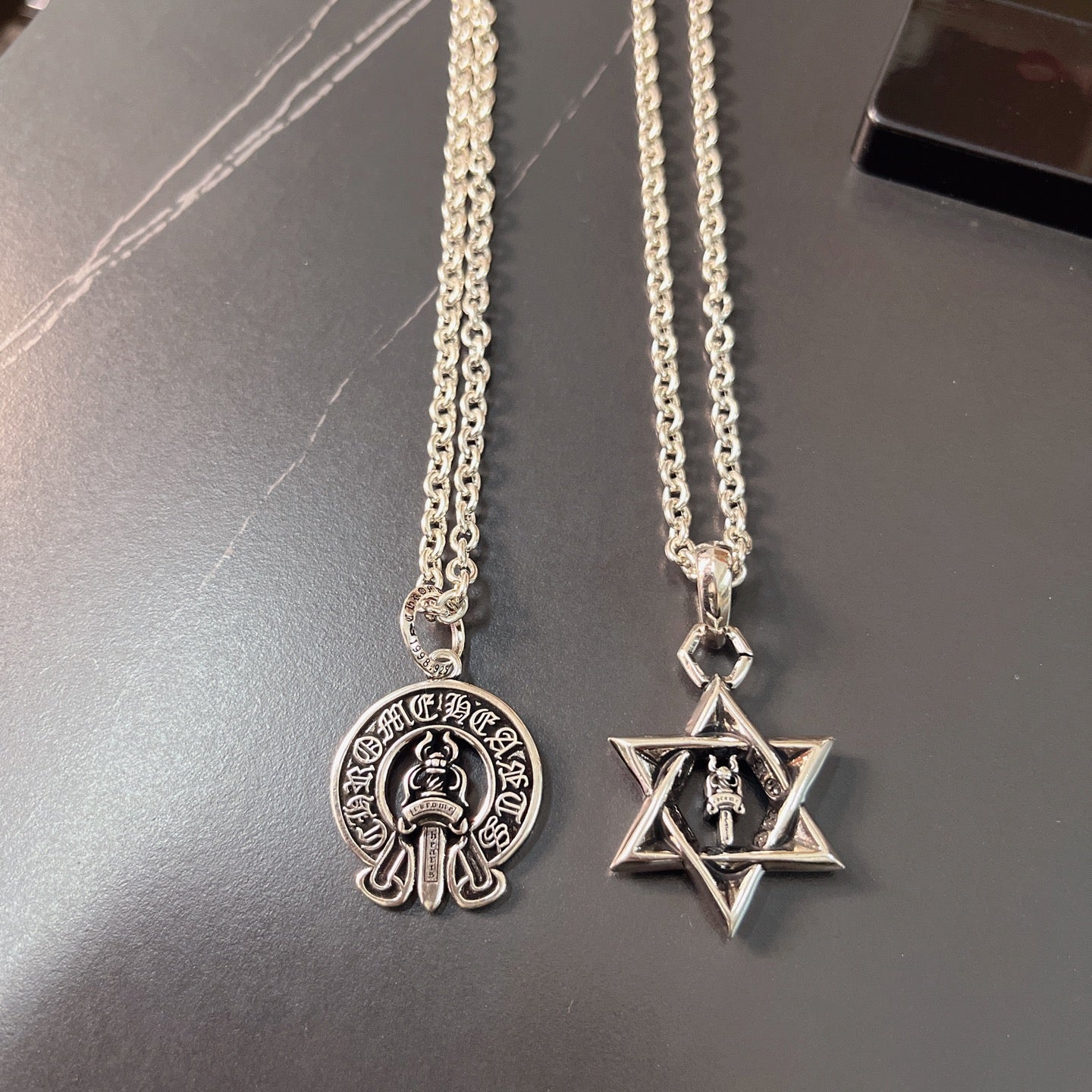 Silver pendant necklaces with round emblem and star pendant charms