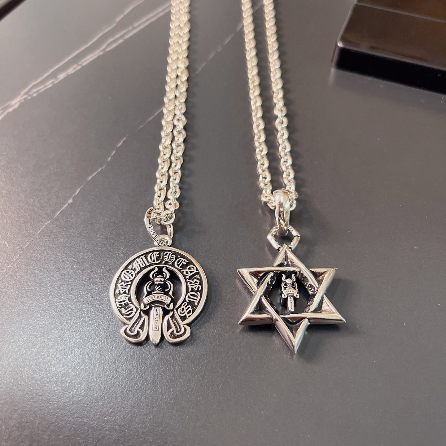 Silver pendant necklaces with round emblem and star pendant charms