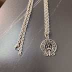 Silver chain necklace with round emblem pendant