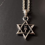 Silver chain necklace with star pendant and black center detail