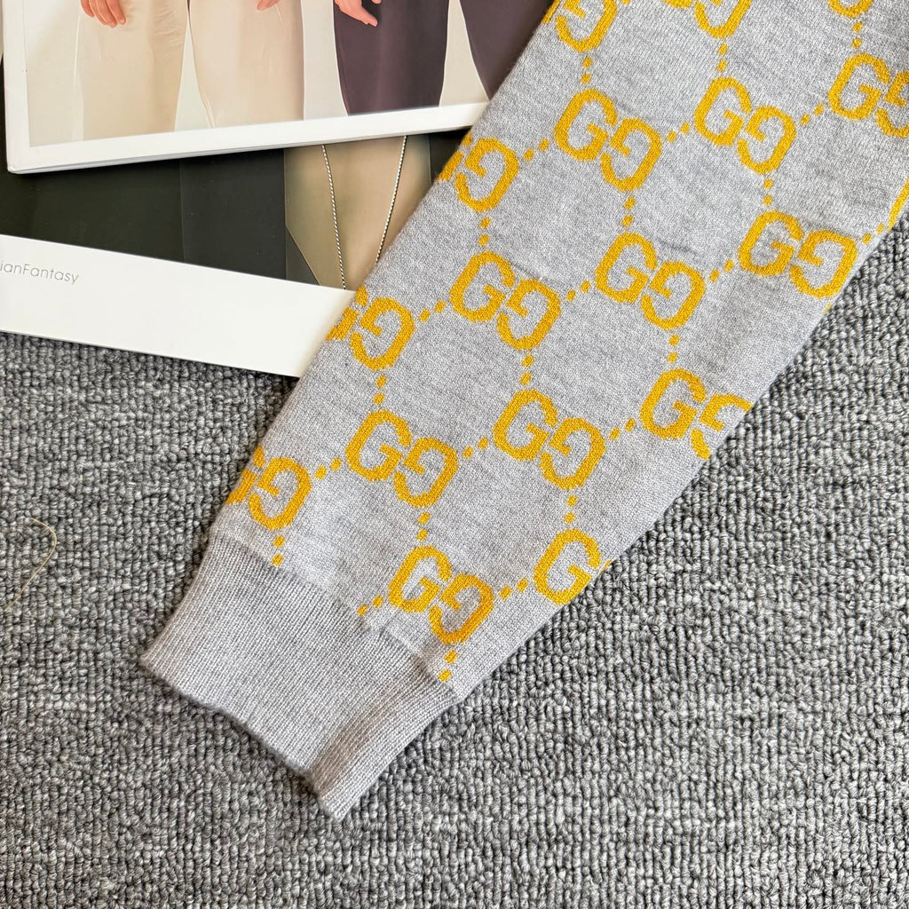 Heather gray sweater with yellow GG logo knit pattern and ribbed sleeve cuff
