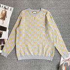 Long-sleeve knit sweater in heather gray with repeating yellow GG logo pattern