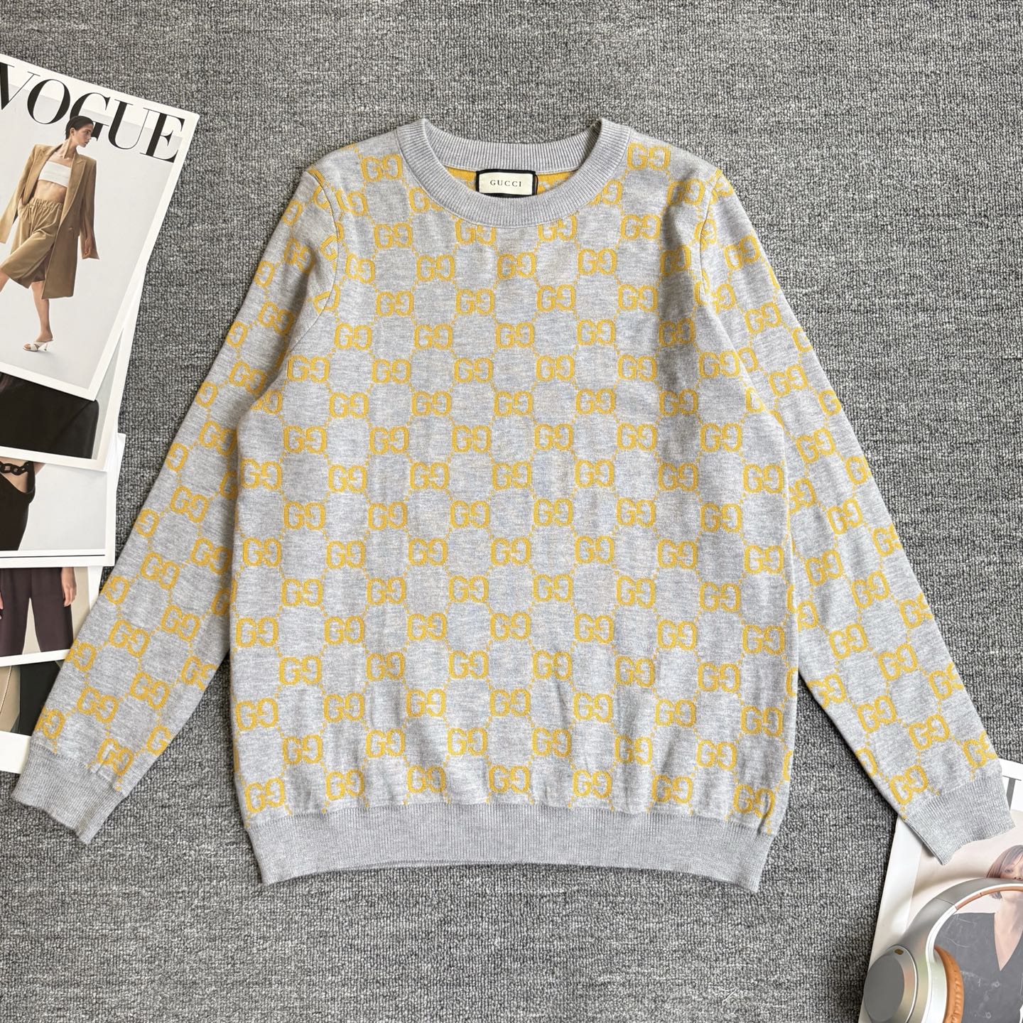 Long-sleeve knit sweater in heather gray with repeating yellow GG logo pattern