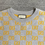 Heather gray sweater neckline with yellow GG logo pattern and ribbed collar