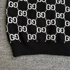 Black knit sweater hem with repeating white GG logo lattice pattern