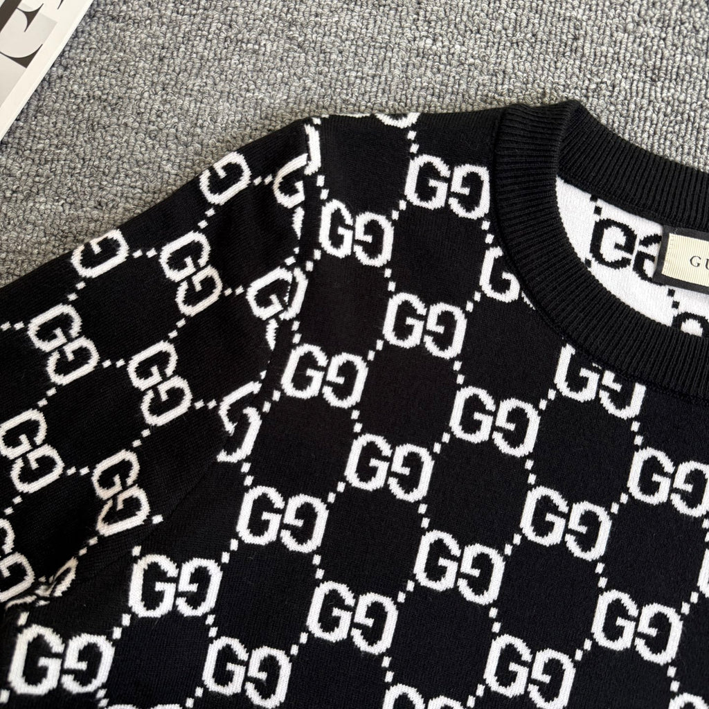 Black knit sweater with white outlined GG logo lattice pattern