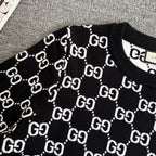 Black knit sweater with white outlined GG logo lattice pattern
