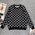 Black knit sweater with repeating white GG logo lattice pattern and ribbed crew neck
