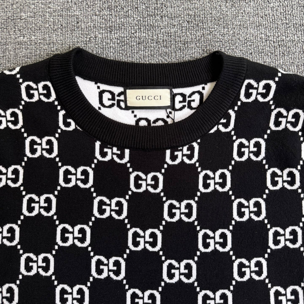 Black knit sweater crew neck with ribbed collar and repeating GG logo pattern