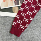 Burgundy Gucci sweater sleeve with white GG diamond pattern knit cuff