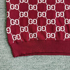 Burgundy Gucci sweater sleeve close-up with white GG diamond pattern and knit cuff