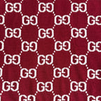 Close-up of burgundy Gucci knit fabric with white GG diamond logo pattern