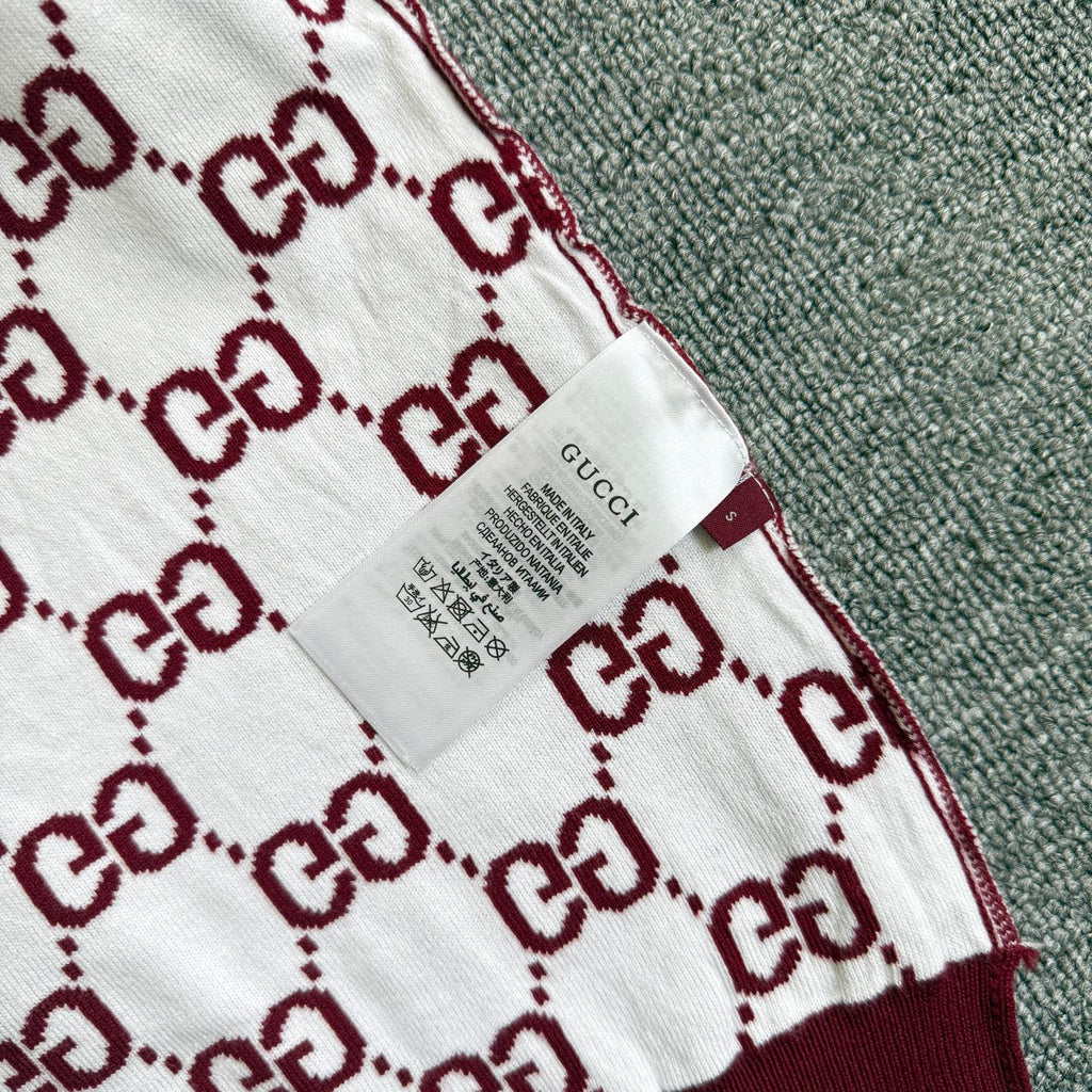 Gucci sweater fabric label on white-and-burgundy GG diamond pattern