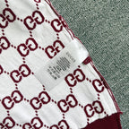 Gucci sweater fabric label on white-and-burgundy GG diamond pattern