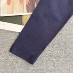 Navy Dior cardigan sleeve with knit cuff, plain fabric with no visible graphics