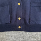 Navy Dior cardigan front with gold buttons and ribbed hem below the placket