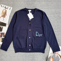 Navy Dior cardigan sweater with front button placket, patch pockets, and Dior logo