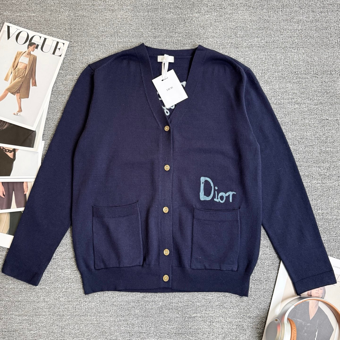 Navy Dior cardigan sweater with front button placket, patch pockets, and Dior logo