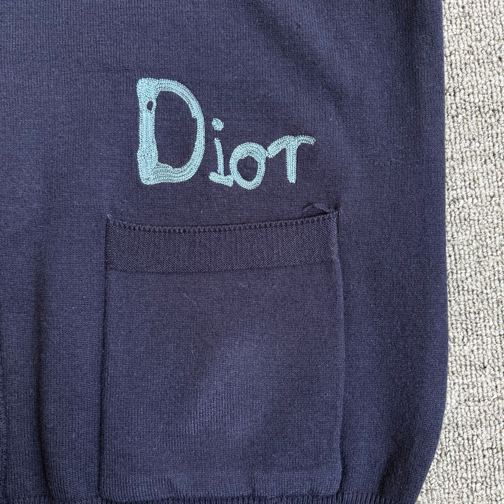 Navy Dior cardigan chest pocket with embroidered "Dior" logo on the left side