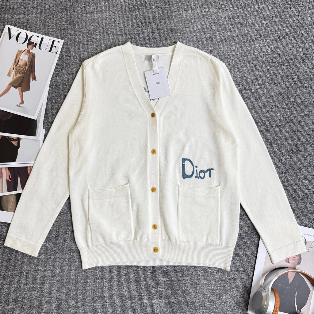 White long-sleeve cardigan sweater with V-neck, button front, and chest pockets