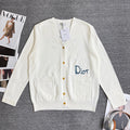 White long-sleeve cardigan sweater with V-neck, button front, and chest pockets