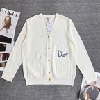 White long-sleeve cardigan sweater with V-neck, button front, and chest pockets