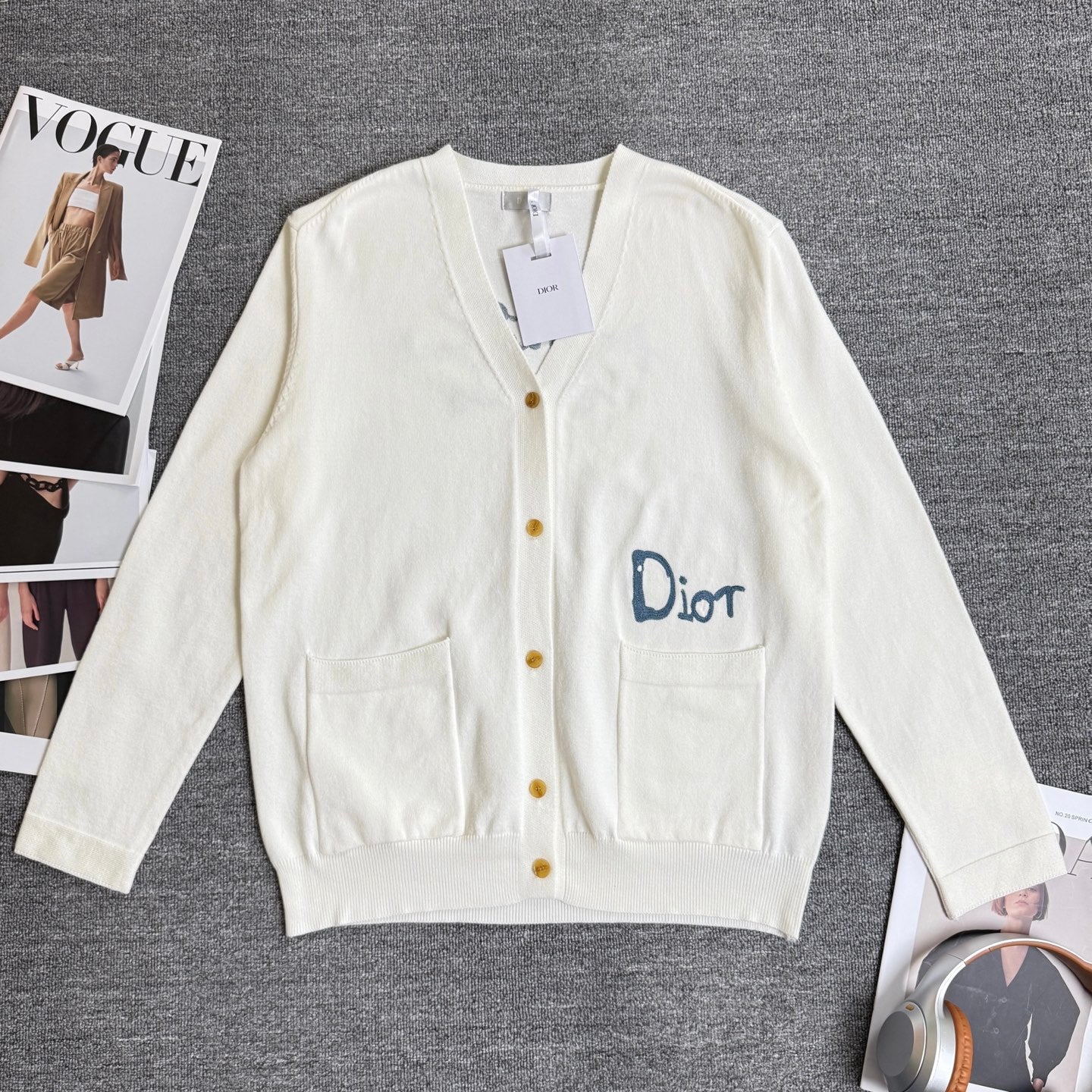 White long-sleeve cardigan sweater with V-neck, button front, and chest pockets