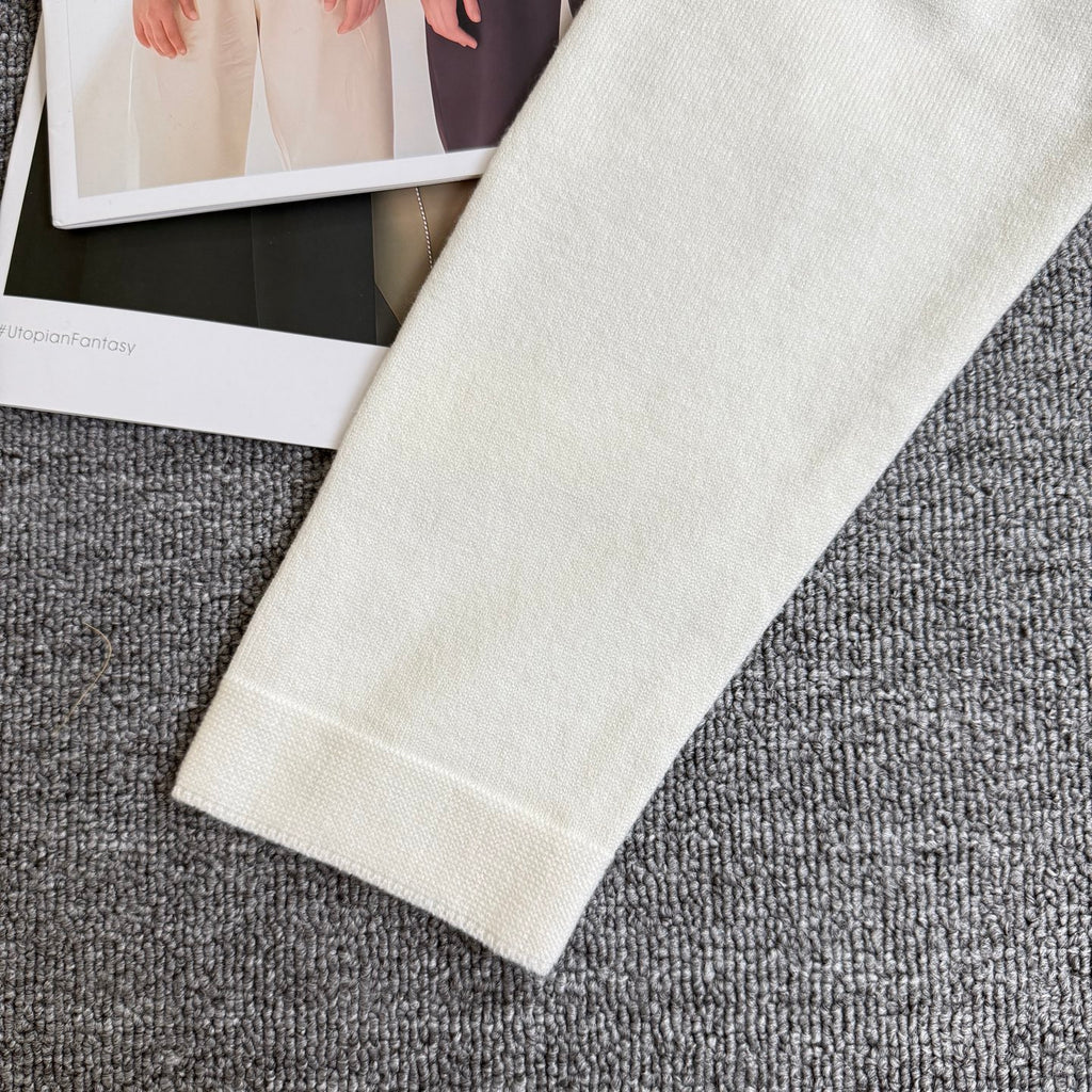 White knit cardigan sweater sleeve cuff and hem with ribbed knit detail