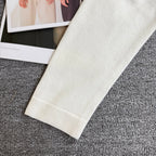 White knit cardigan sweater sleeve cuff and hem with ribbed knit detail
