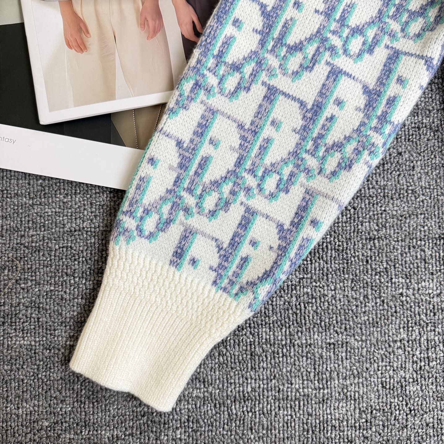 Long knit cardigan sleeve detail with ribbed cream cuff and light blue patterned knit