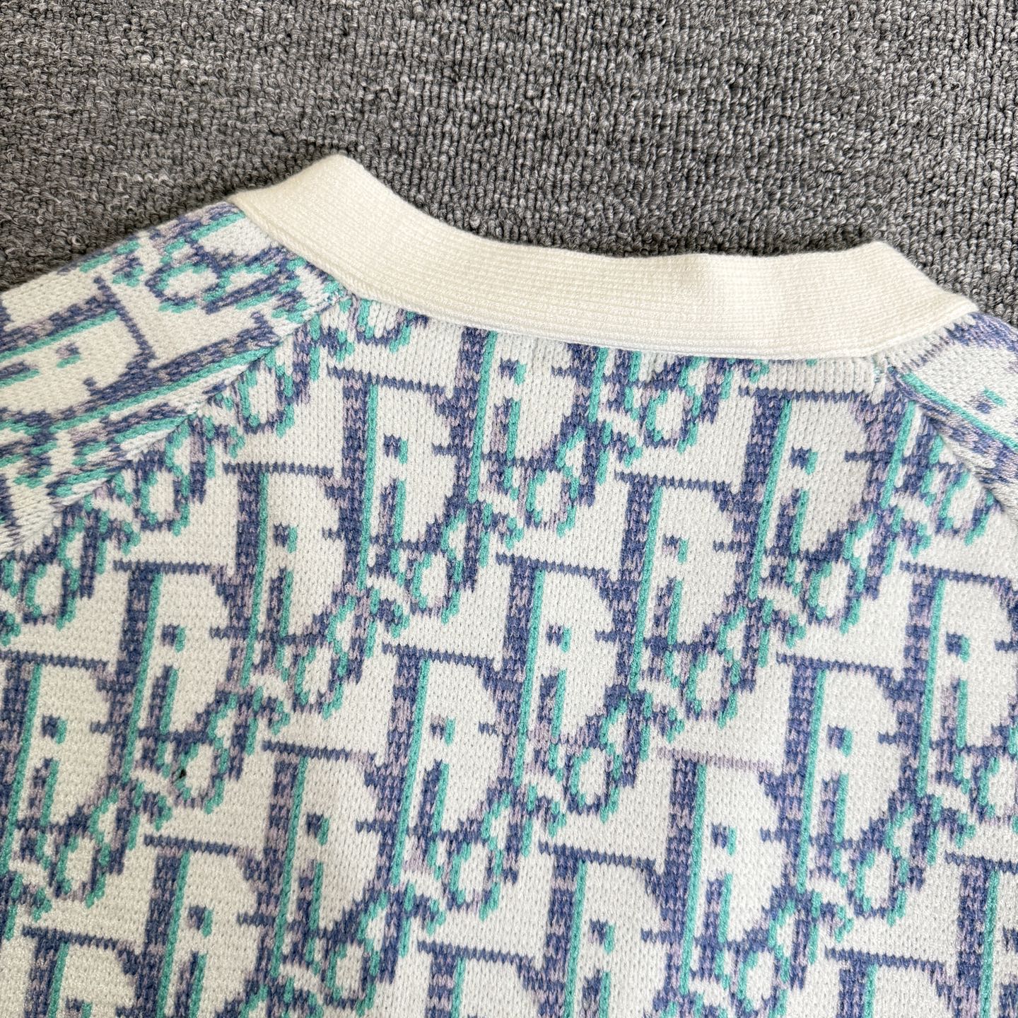Ribbed crew collar on light blue and white patterned knit cardigan