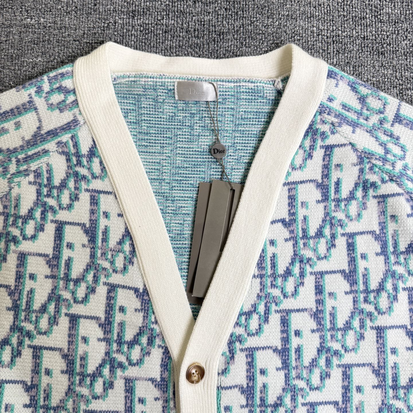 Knit cardigan V-neck with cream trim and button placket, light blue patterned fabric