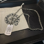 Silver-tone chain necklace with rectangular dog-tag pendant on pouch