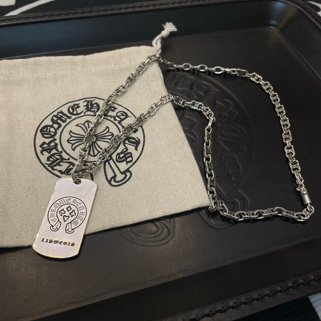 Silver-tone chain necklace with rectangular dog-tag pendant on pouch