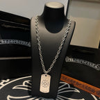 Silver-tone chain necklace with rectangular dog-tag pendant on display