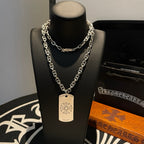 Silver-tone chain necklace with small flower emblem dog-tag pendant